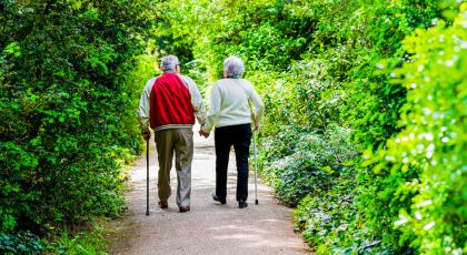 Elderly couple out walking with walking sticks