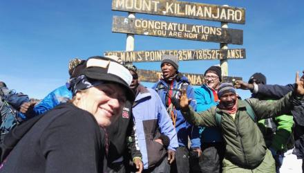 Corrine Hutton at the summit of Mount Kilimanjaro