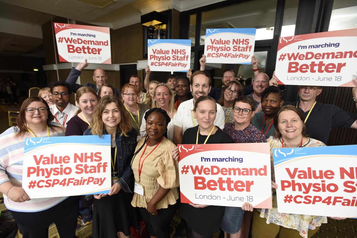 CSP delegates at Annual Representatives Conference hold banners promoting a fair pay rise for NHS staff