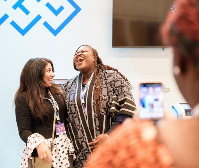 2 delegates at annual conference laughing together