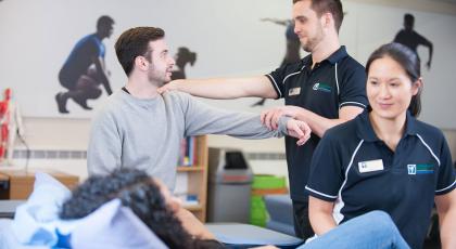Two physios working with patients