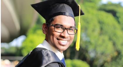 a young man wearing a graduate gown and cap