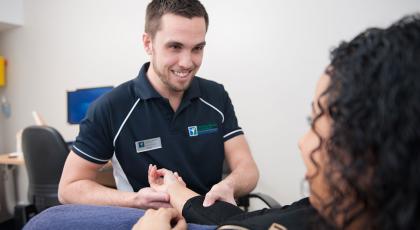 A physio treating a patient's wrist