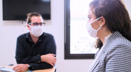 Two people in interview with face mask on