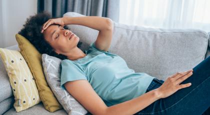 A woman at home suffering from symptoms of Long Covid