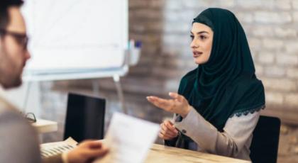 a woman in a hijab having a job interview