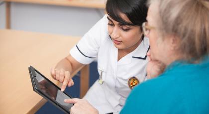 Two physios looking at a page on an ipad