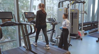 Physio supervising a patient on a treadmill