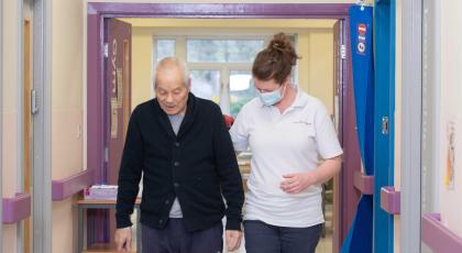 Patient and physio in hospital corridor