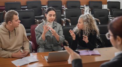 A lecturer and students communicating in sign language in the classroom