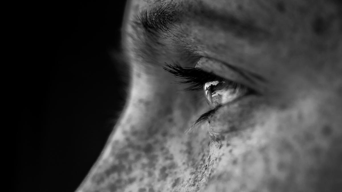 Image of a man in profile staring thoughtfully