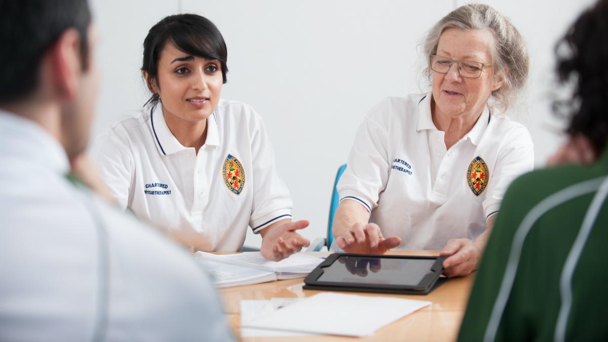 Physios in a meeting NICE is looking for two physios to join its osteoarthritis guideline committee