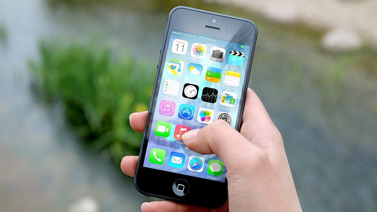 a person using an iphone with apps displaying onscreen