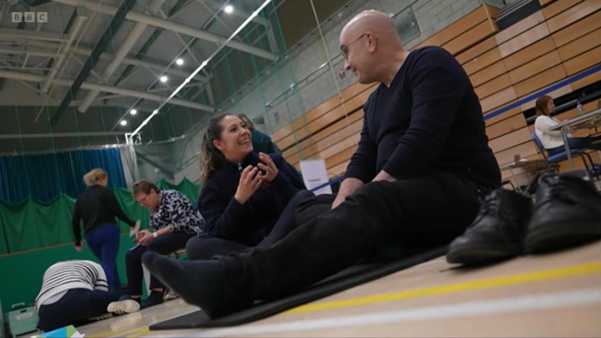 A patient speaks to a physio in a leisure centre during the Community Appointment Day in Crawley. 
