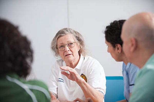 A physiotherapist talking with colleagues
