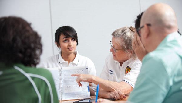 Physiotherapists taking part in a discussion with health professionals