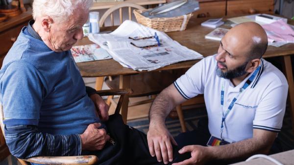 FLJul26Cover Senior physiotherapist Ali Shah with patient James Beaumont at a home visit