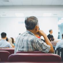 Patients sit in a waiting room
