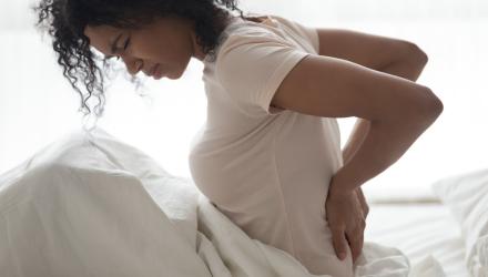 Woman waking up with back pain
