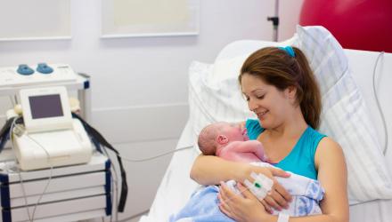 mother with new baby in hospital bed