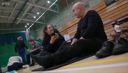 A patient speaks to a physio in a leisure centre during the Community Appointment Day in Crawley. 