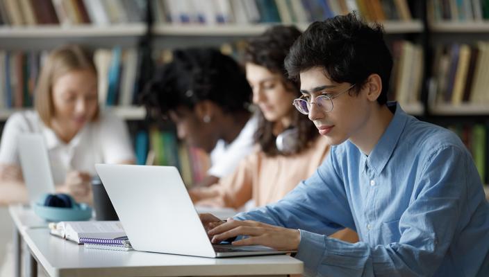 Students make notes in a library