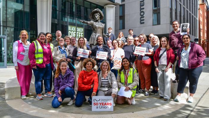 CSP members standing by the Emeline Pankhurst statue in Manchester on a walking fringe event