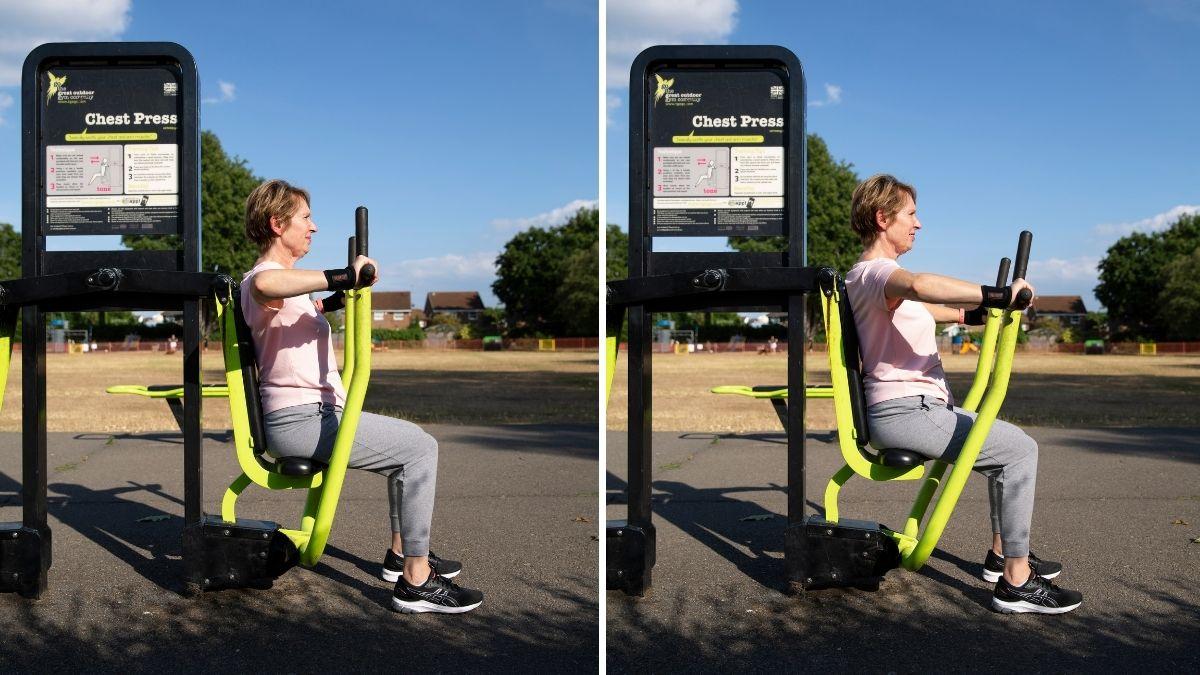 Photograph of a woman using a chest press at the park