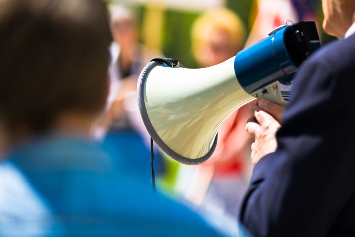 Person with a loudspeaker at a picket line