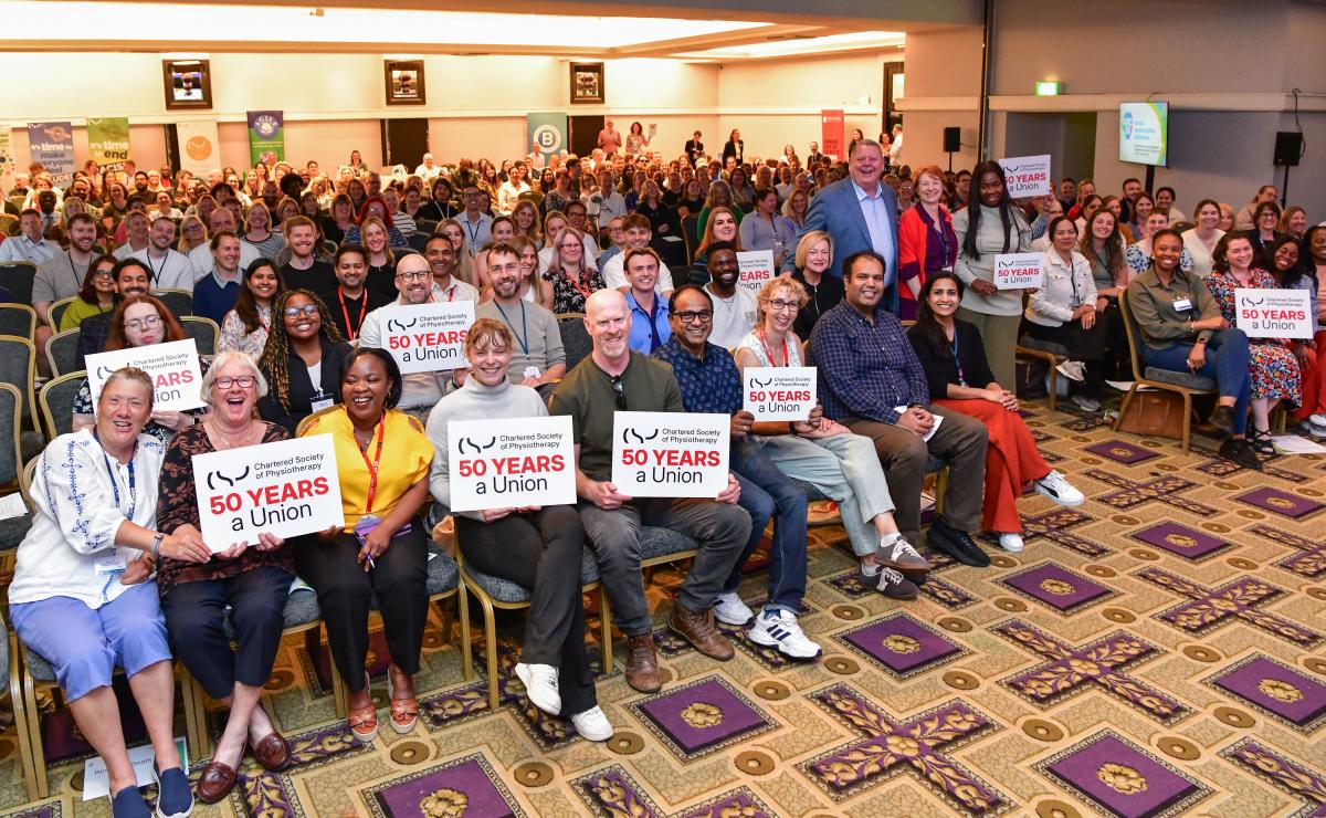 Delegates at ARC event holding placards marking 50 years of the CSP as a union